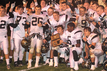 Paola varsity players hoist their district championship plaque after beating Louisburg Thursday October 27. 