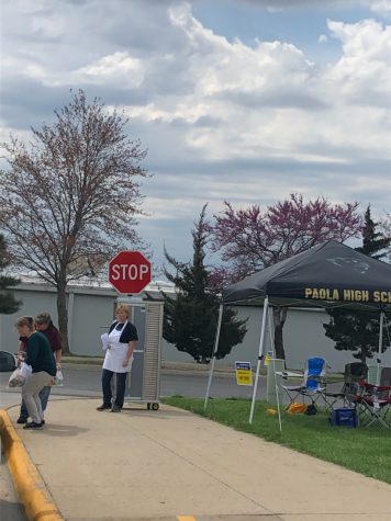 Parents drive through the high school parking lot during meal pickup provided by USD 368 for breakfast and lunch for children ages 1-18 on April 2. Food service workers enjoyed helping families in need and seeing familiar faces again, said Rita Wobker, food service worker.