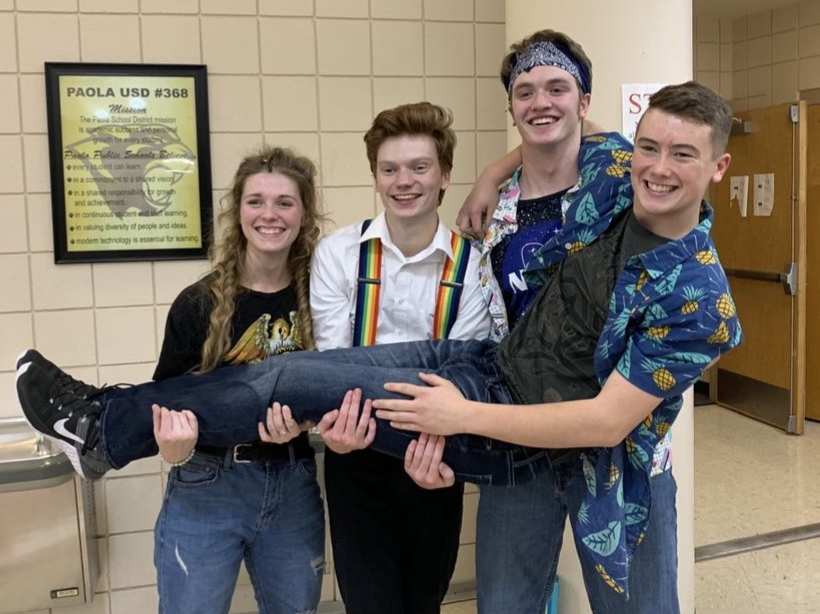 Freshman Layne Anderson felt supported by senior Jacob Farmer, second from left, as a freshman. Seniors Ashley Schwach, left and Creighton Markovich hold Anderson up after the production of Godspell this fall. 