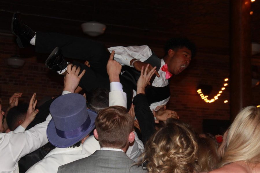 Jovanni Blackie, junior, crowd surfs during Prom at Town Square April 24. 