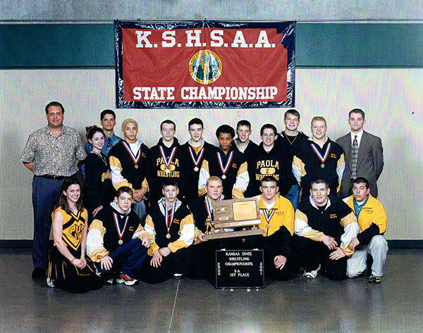 Steve Gorsuch, former head wrestling coach, stands with champion wrestlers in 2001.